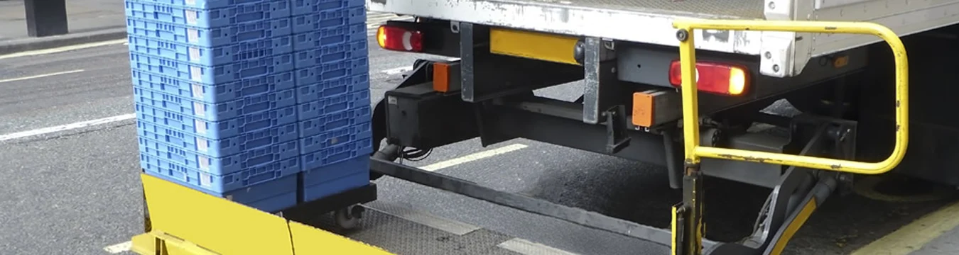 Crates on a loading platform beside a delivery vehicle